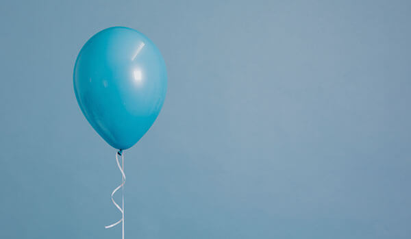A single blue balloon on a string