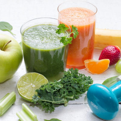 Picture of green smoothies, vegetables, and a exercise weight