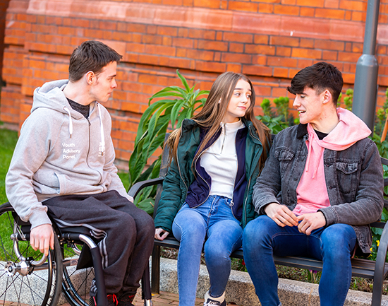 Picture of young people chatting,with one in a wheelchair