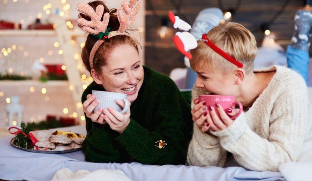 Space to talk happy-young-women-drinking-hot-tea-coffee-bed