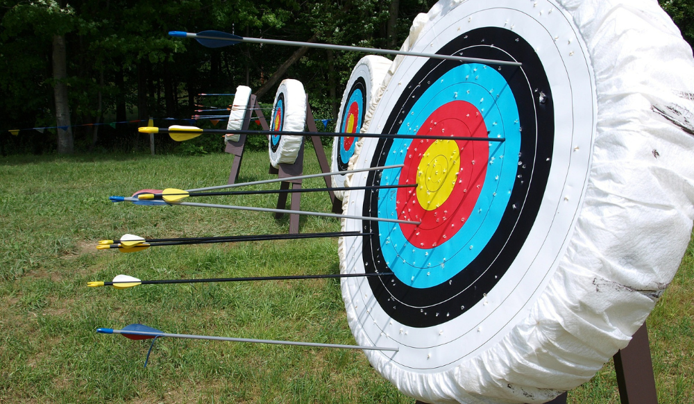 numerous archery target with arrows in