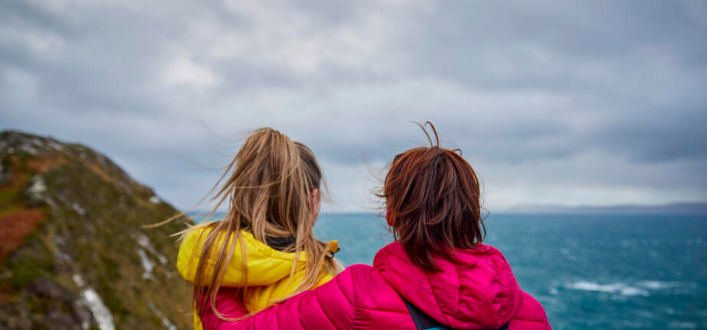 two women looking out to sea (1374 × 643 px)